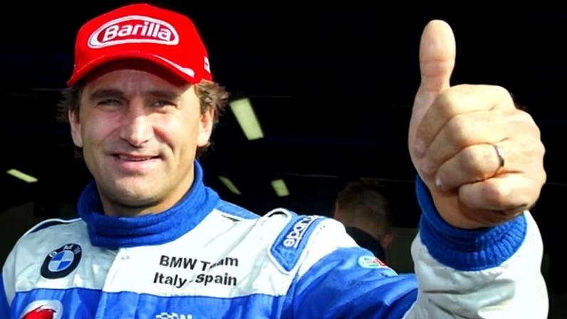 Alex Zanardi gives a thumbs up before the start of a car event at the Monza race track in 2003 on his return to racing after he lost both his legs in a crash.