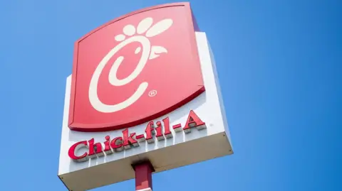 Getty Images The red and white Chick-fil-A sign against a bright blue sky