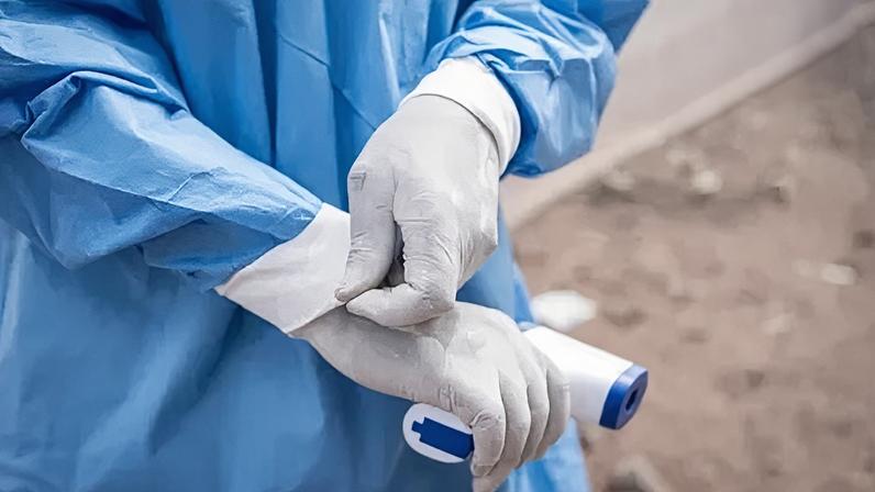 EPA A close-up of a medical staff holding a thermometer