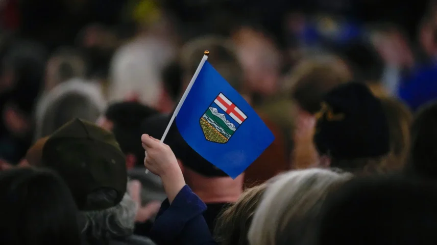 An attendee holds an Alberta flag during the Alberta Independence town hall event in Calgary in January.