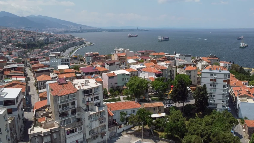 Cargo vessels in the Aegean sea along the coastline in Izmir, Turkey.