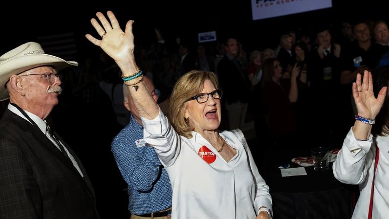 Ken Paxton supporters cheer during a runoff election night event in Plano.