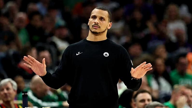Celtics coach Joe Mazzulla gestures to his team to calm down during a game against the Phoenix Suns.