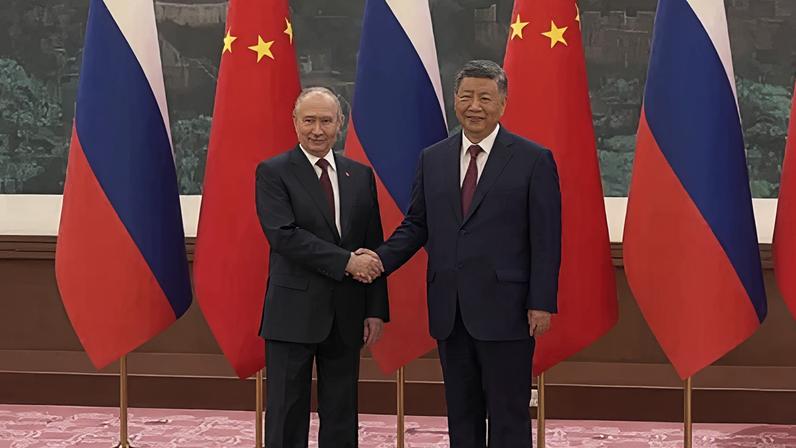 Xi e Putin posam para as câmeras antes do início das negociações em Pequim, nesta quarta-feira (20)