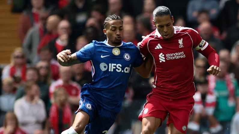 João Pedro and Virgil van Dijk battle for posession.