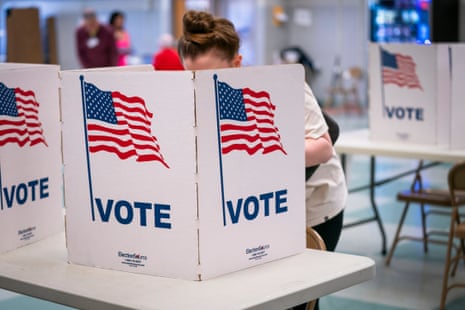 People cast their votes on new maps at the Whitman middle school polling location in Alexandria, Virginia, on 21 April.
