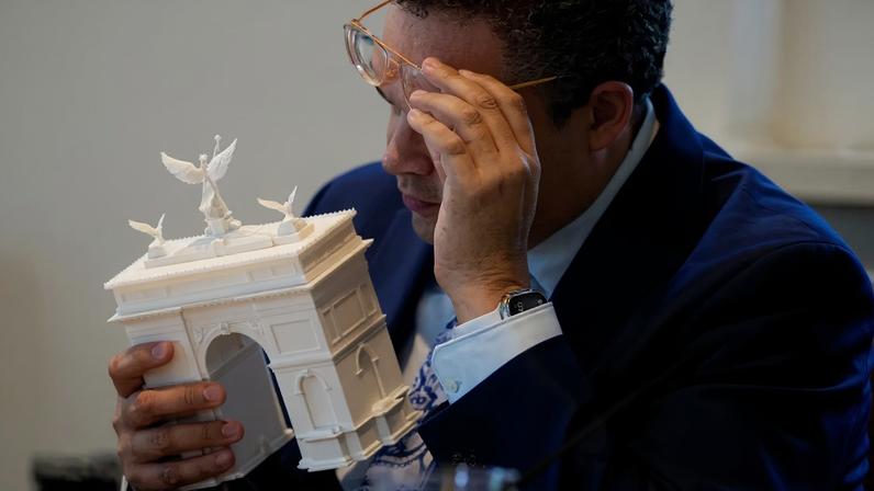 WASHINGTON, DC - APRIL 16: Commission of Fine Arts commission member Matthew Taylor inspects a model of President Donald Trump's proposed triumphal arch to commemorate the country's 250th anniversary.