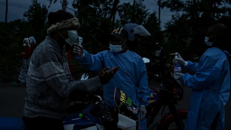 Health care workers check temperatures as people pass through a checkpoint in Goma, Democratic Republic of Congo on Thursday.