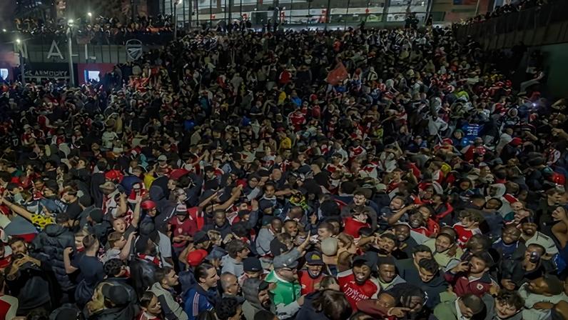 Jubilant Arsenal supporters celebrate outside the Emirates Stadium. Photograph: Marcin Nowak/LNP
