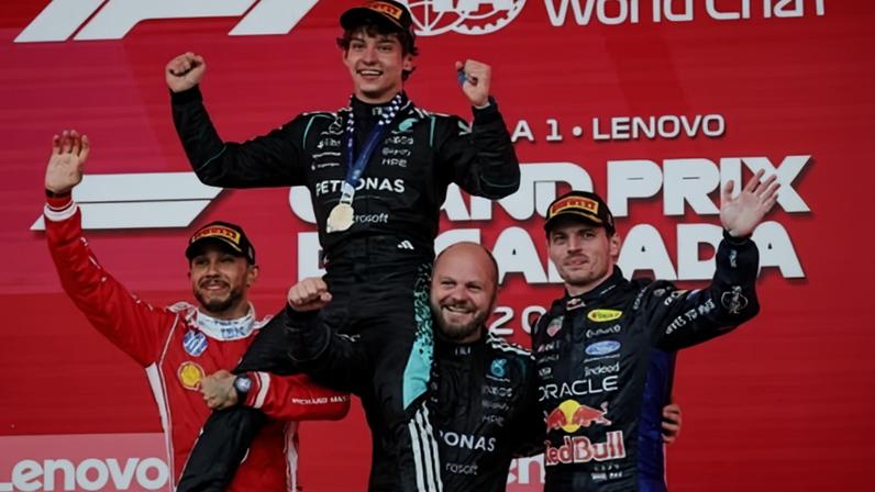 Kimi Antonelli is lifted by (from left) Lewis Hamilton, who finished second, Mercedes official Dean Hale and Max Verstappen, who was third.