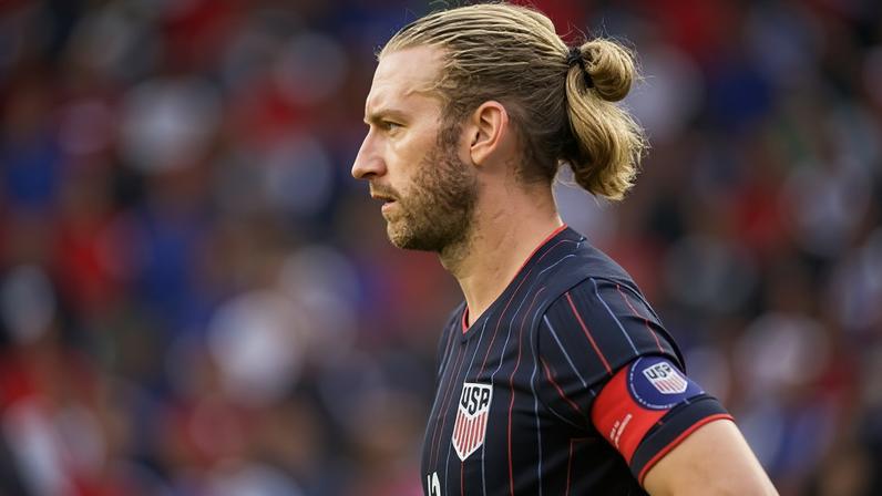 Tim Ream in a dark pinstriped USA jersey with captain's armband stands in profile