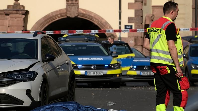 Rescue workers stand next to a damaged car that crashed into several people in Leipzig.