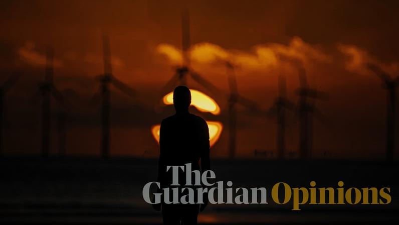 The sun sets behind Burbo Bank offshore wind farm and an iron figure, part of Anthony Gormley’s Another Place, at Crosby, Merseyside.