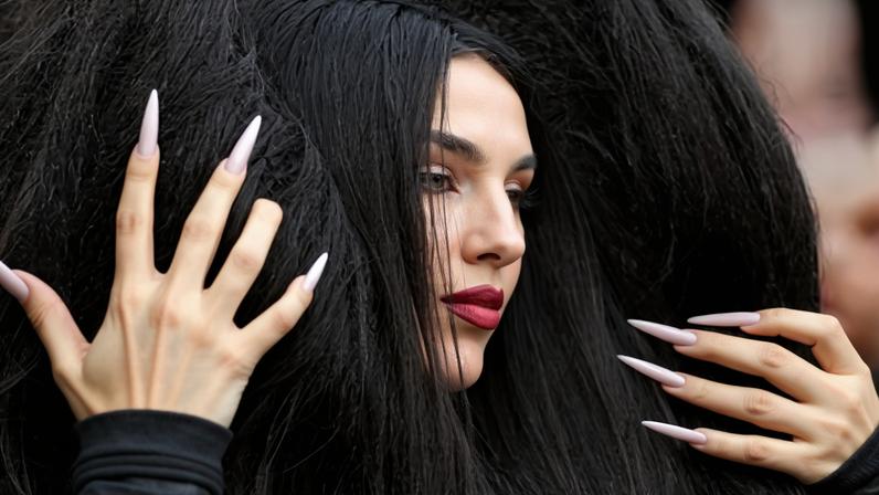 Tamara Živković representing Montenegro poses for photographers on the turquoise carpet at Sunday’s opening ceremony for the Eurovision song contest 2026 in Vienna.