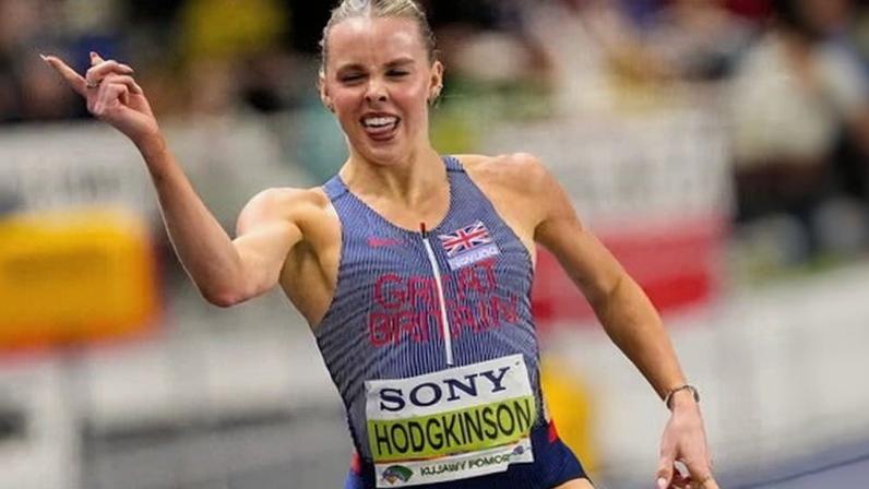 Keely Hodgkinson gestures as she crosses the finish line to win 800m gold in at the World Athletics Indoor Championships in Torun, Poland