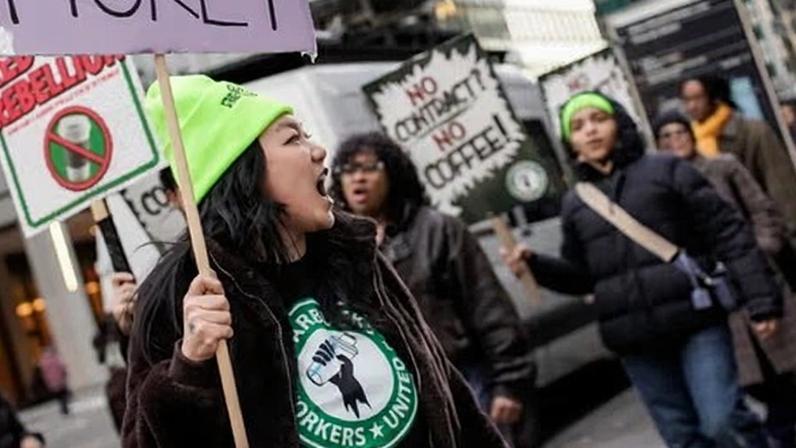 Workers picket outside a Starbucks on 20 November 2025 in New York.