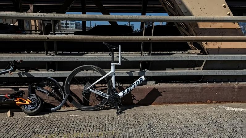 A bike was snapped in half after a collision with a scooter on the Queensboro Bridge.