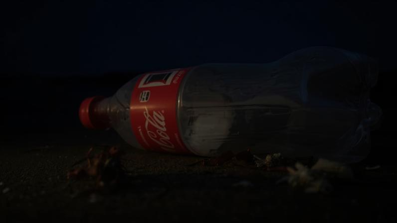 A plastic Coca-Cola bottle on a beach. Plastic bottle caps have been identified as among the top items found littering European beaches.