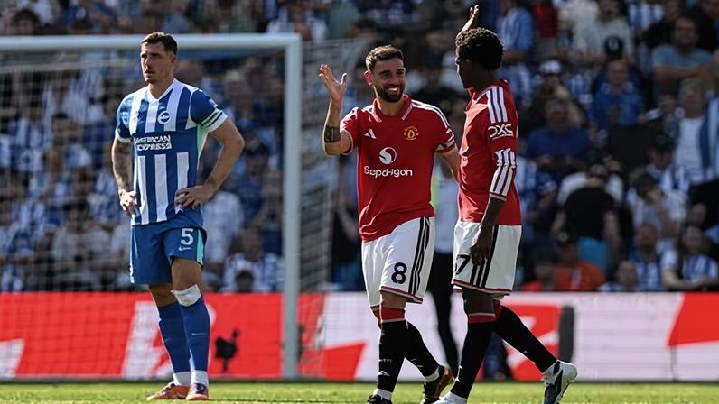 Bruno Fernandes celebrates breaking the Premier League record for assists with Kobbie Mainoo after Patrick Dorgu scored Manchester United’s first goal.