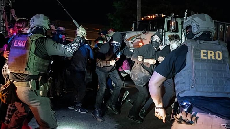 ICE agents hit protesters with batons outside Delaney Hall detention facility in Newark, New Jersey.