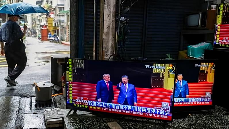 TVs at a repair shop in Taipei, Taiwan, broadcasting the Beijing meeting between Trump and Xi.