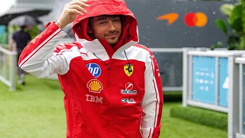 Charles Leclerc shelters from the rain as the Miami GP awaits.