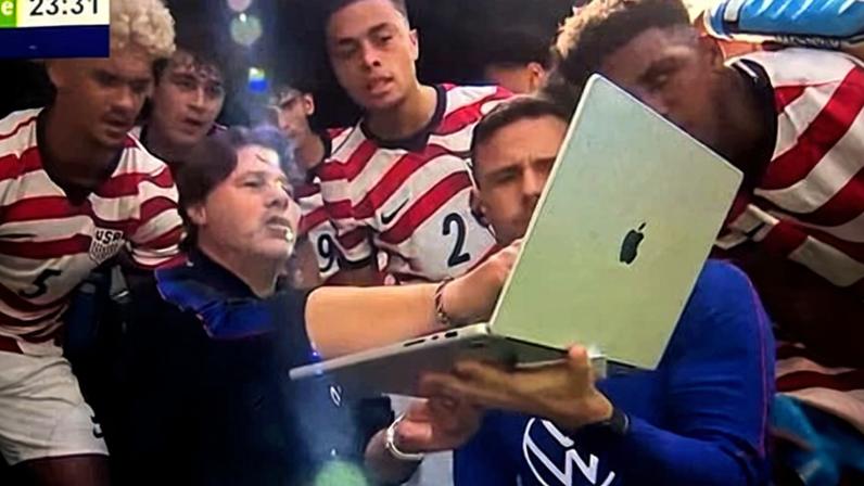 As shown on the TV broadcast, Mauricio Pochettino gestures at a laptop midway through the first half.
