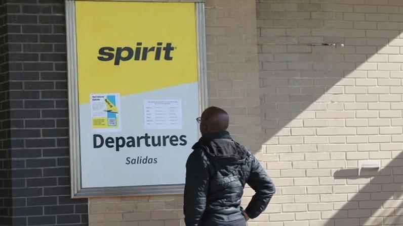 A passenger reads a notice of Spirit Airlines at LaGuardia airport in New York on 3 May.