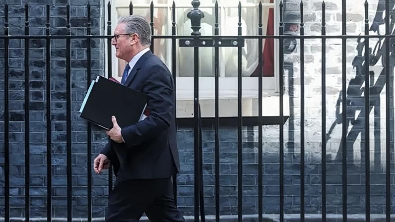 Reuters Prime Minister Keir Starmer walks outside 10 Downing Street on 22 April, 2026.