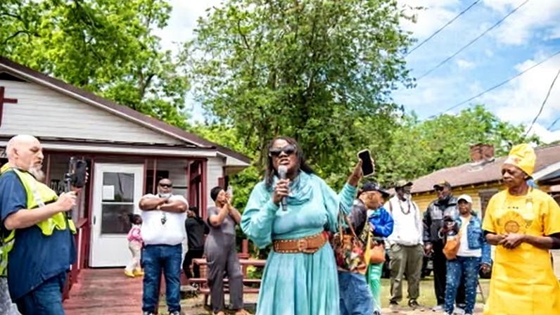 Letetia Jackson, Dothan resident and plaintiff in a redistricting lawsuit, speaks at the Tops Unity Day Parade on 1 May.