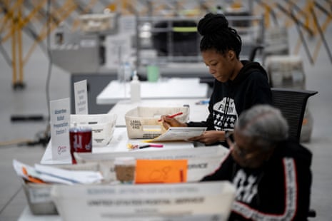 Fulton county workers process absentee ballots ahead of the US presidential election in Atlanta, Georgia, on 4 November 2024.