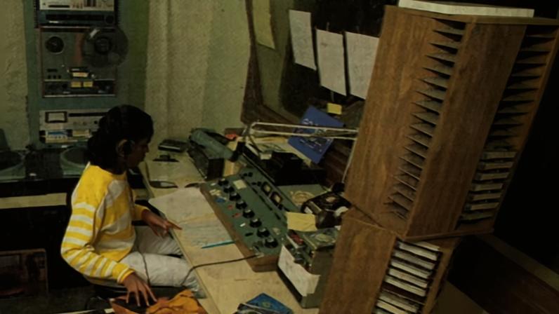 A student working at WJSU Radio.