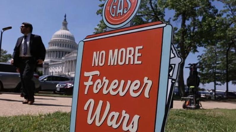 A placard against the Iran war at an event outside the US Capitol, Washington, 20 May 2026.