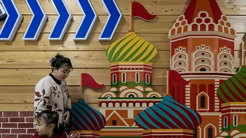 A Chinese woman and a young girl at a mall selling Russian goods in Suifenhe, China.