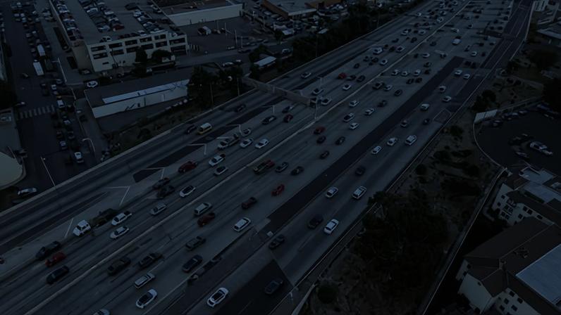 An aerial view of a freeway with many lanes.