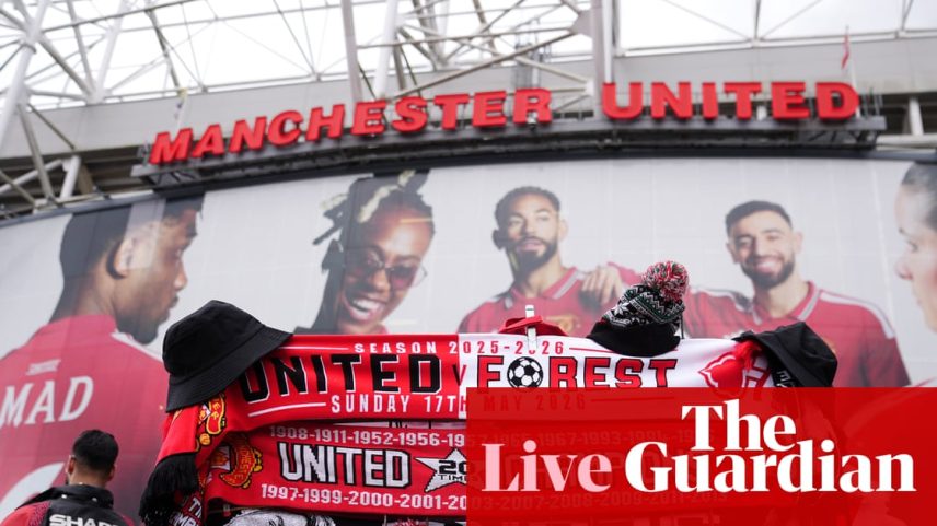 A display of red, white and black Manchester United scarves and hats for sale outside Old Trafford