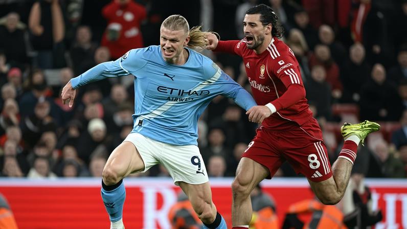 Erling Haaland of Manchester City is tugged back by Dominik Szoboszlai in a slapstick comedy finale to Liverpool’s 2-1 defeat at Anfield.