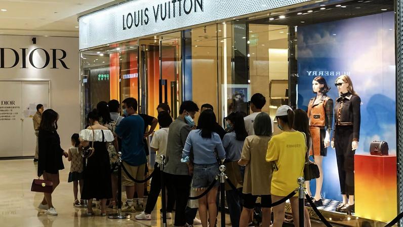 A line of customers outside a luxury store in Chengdu, China. Getty Images.