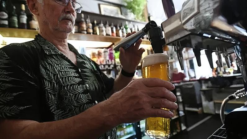 EPA A pub landlord pulls a pint at a pub in London, Britain, 30 August 2022.