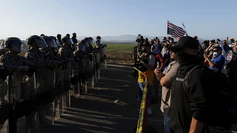 California national guard troops face off with protesters during an immigration raid on Glass House Farms in Camarillo, California, on 10 July 2025.