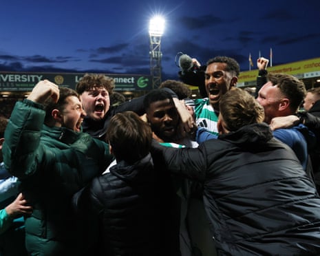 Kelechi Iheanacho (centre) is mobbed by fans after scoring Celtic’s added-time winner at Fir Park.