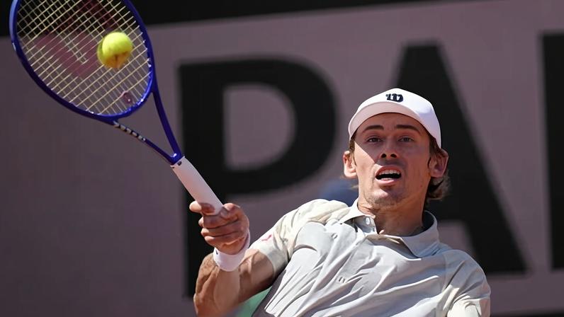 Alex De Minaur of Australia returns to Toby Samuel of Britain during their first round men's singles match.