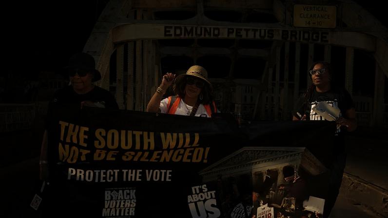 Participants from a coalition of voting rights groups march over the historic Edmund Pettus Bridge in Selma, Alabama, on 16 March 2026, following a prayer service at Tabernacle Baptist Church.