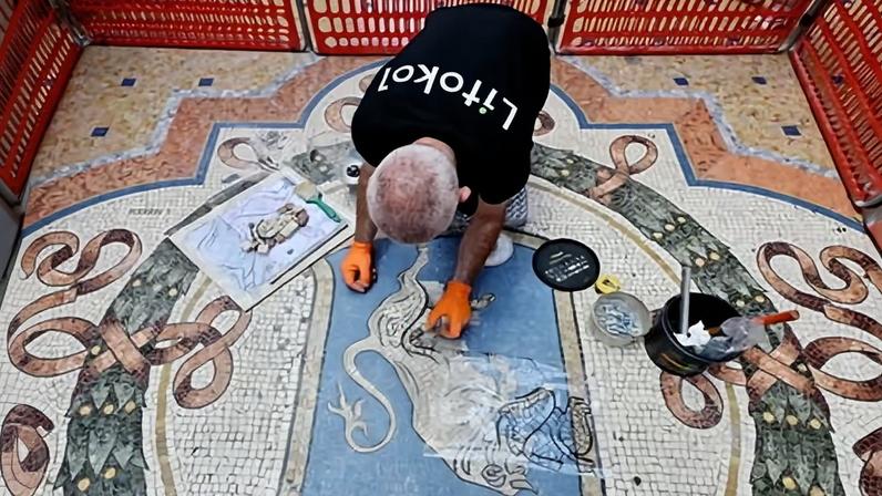 Gianluca Galli, a restorer, works on the mosaic at the Galleria Vittorio Emanuele II in Milan.