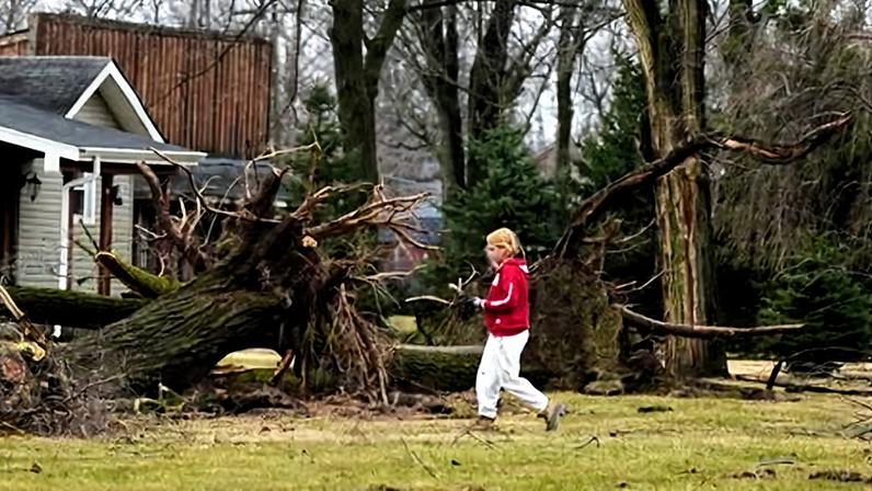A volunteer works to clear debris after a suspected tornado hit the area a day earlier, in Union City, Michigan, on 7 March 2026.