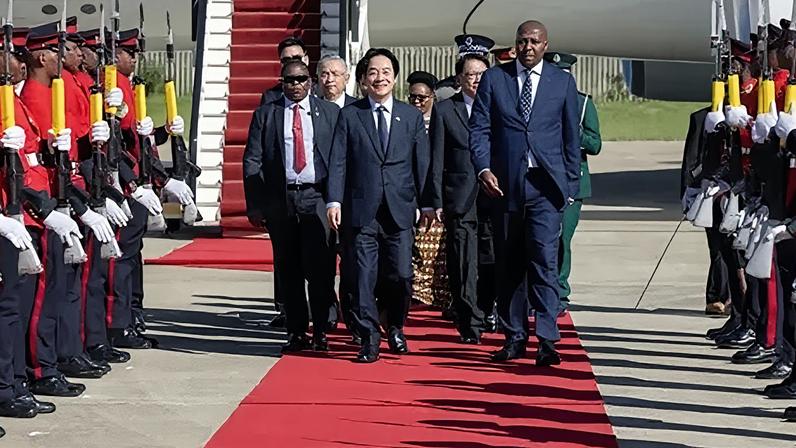 Taiwan Presidential Office Handout Taiwan President Lai Ching-te walks along a red carpet beside an aircraft, flanked by an honour guard with rifles and accompanied by Eswatini Prime Minister Russell Dlamini