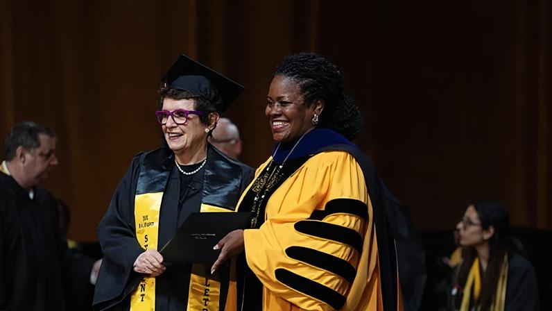 Tennis legend Billie Jean King receives her diploma during commencement in Los Angeles.
