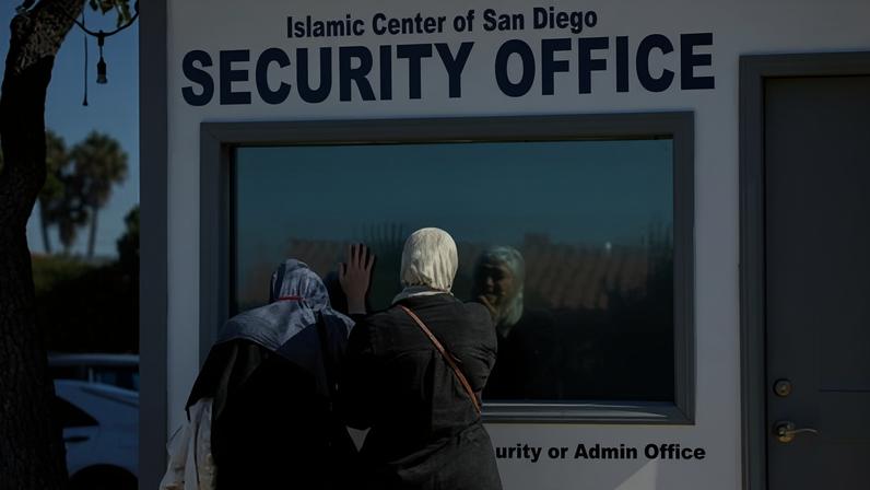 Mourners react by the security office at the Islamic Center of San Diego, which was used by security guard Amin Abdullah who was fatally shot.