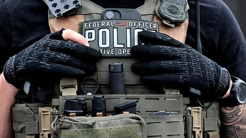 An ICE agents stands guard in front of protesters outside Delaney Hall detention center on 27 May 2026 in Newark, New Jersey.