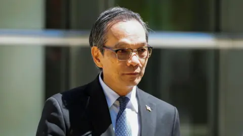 Reuters Lu Jianwang, a US citizen convicted with conspiring to act as an agent of the Chinese government, exits Brooklyn Federal court during his trial in New York City on 12 May 2026.
